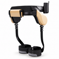 Khaki and black wearable walking exoskeleton on a white background